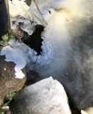Ice from fish pond waterfall